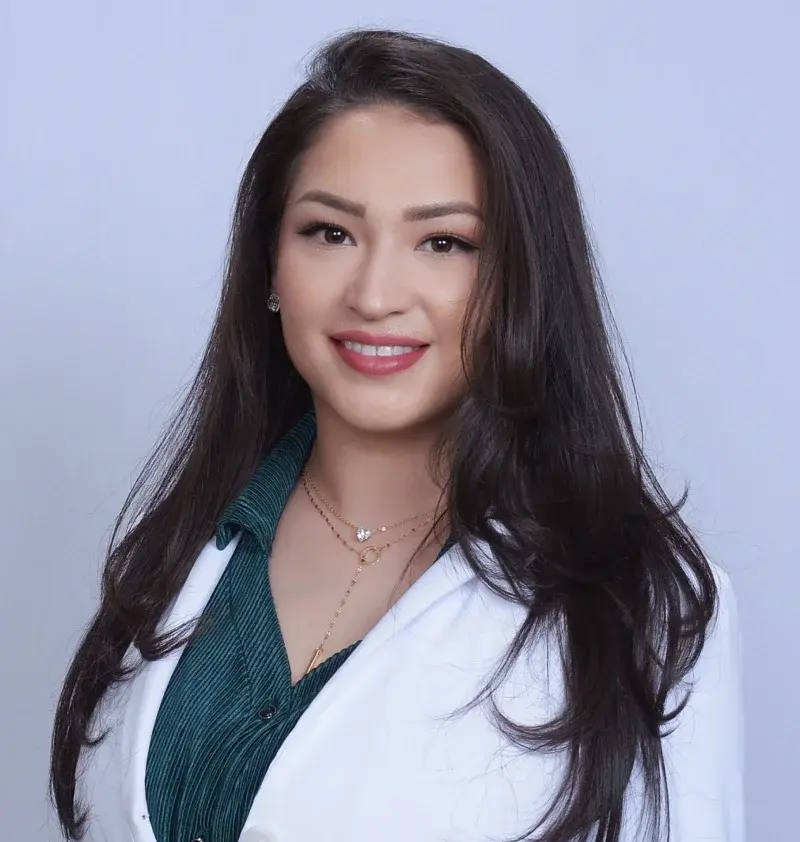 Professional female dentist smiling at Albuquerque dental practice.